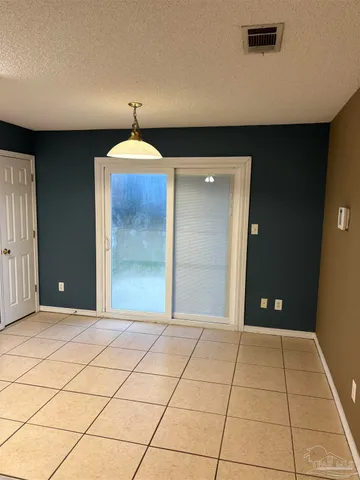 a view of a hallway with a chandelier fan and a livingroom