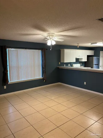 a kitchen with granite countertop a refrigerator and a stove top oven