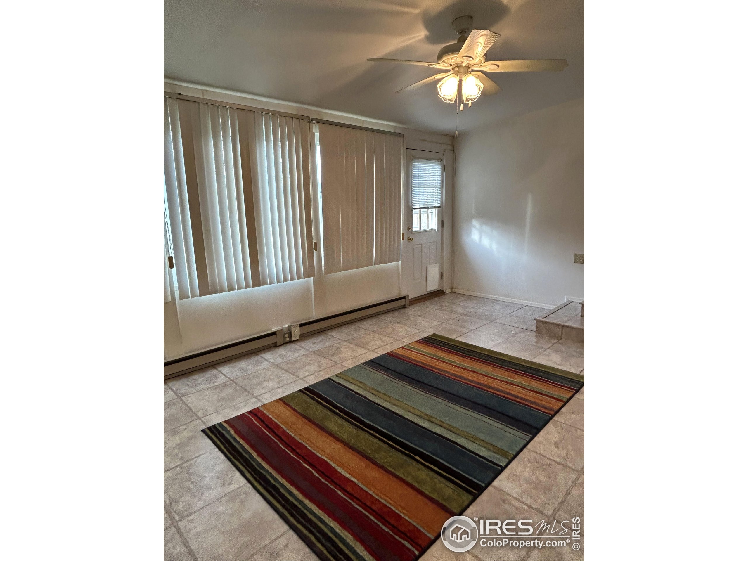 123 Balsam Street Fort Morgan, CO 80701 - Photo 13 of 34 a living room with furniture and a rug
