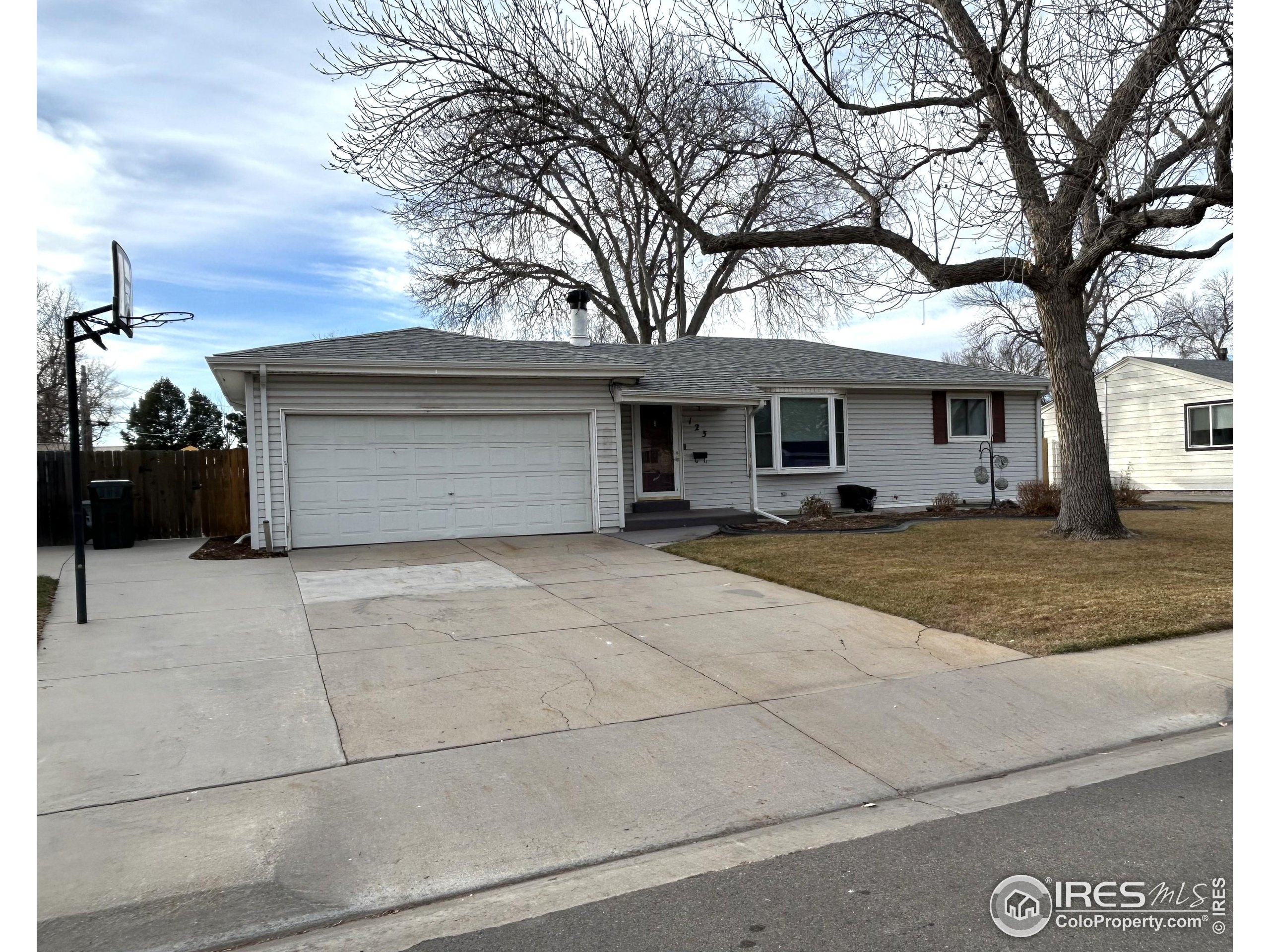 123 Balsam Street Fort Morgan, CO 80701 - Photo 2 of 34 a front view of a house with a yard and garage