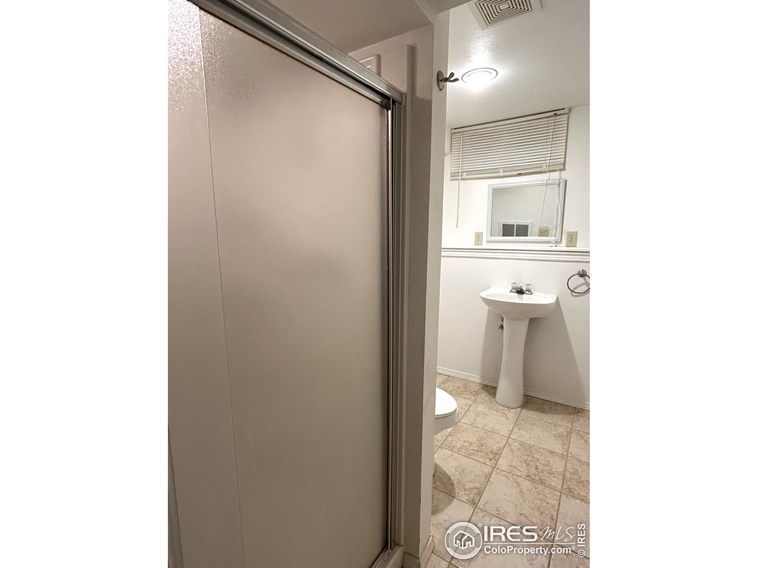 123 Balsam Street Fort Morgan, CO 80701 - Photo 28 of 34 a bathroom with a sink and a mirror
