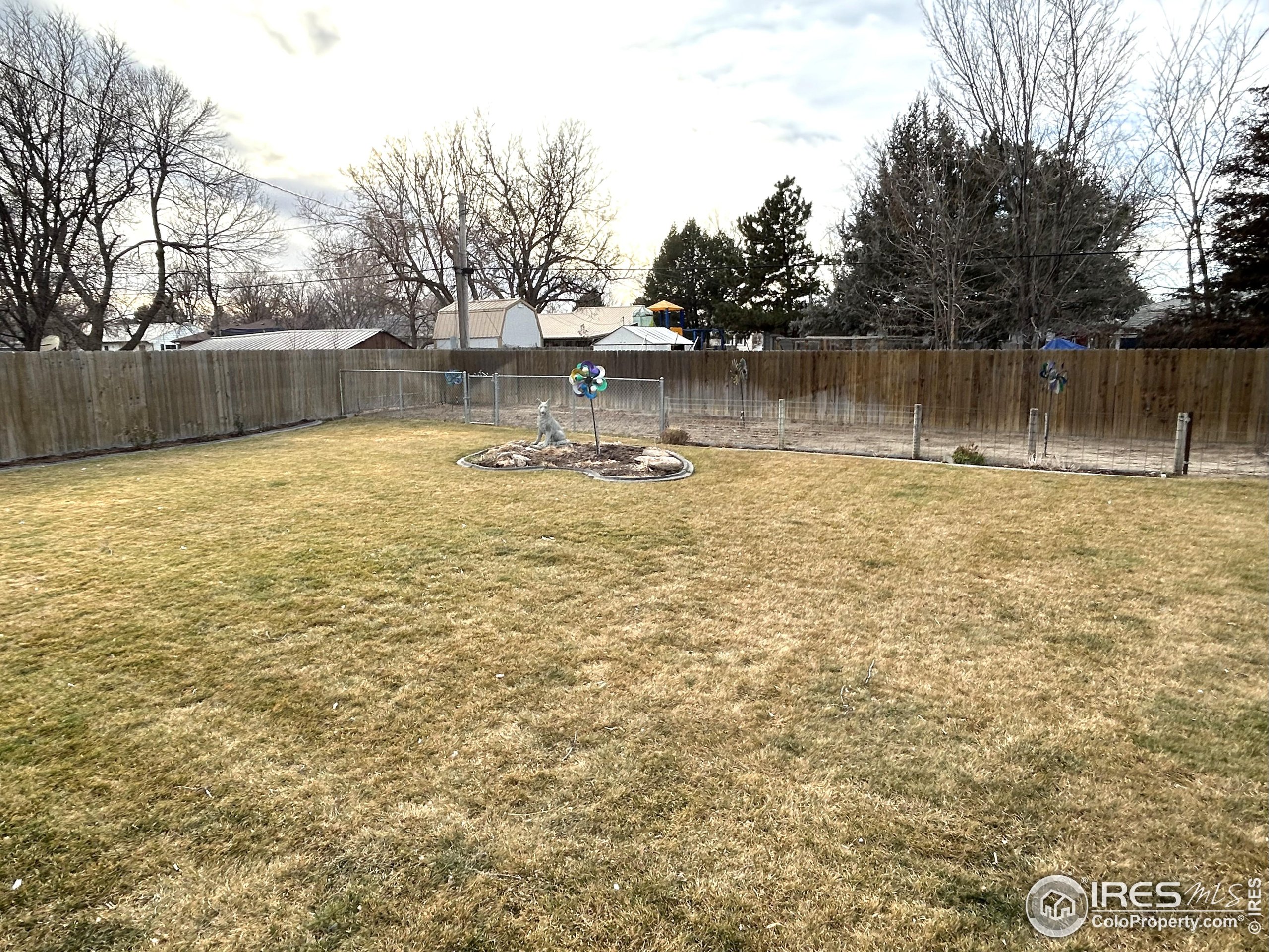 123 Balsam Street Fort Morgan, CO 80701 - Photo 30 of 34 a view of a lake with houses in the back