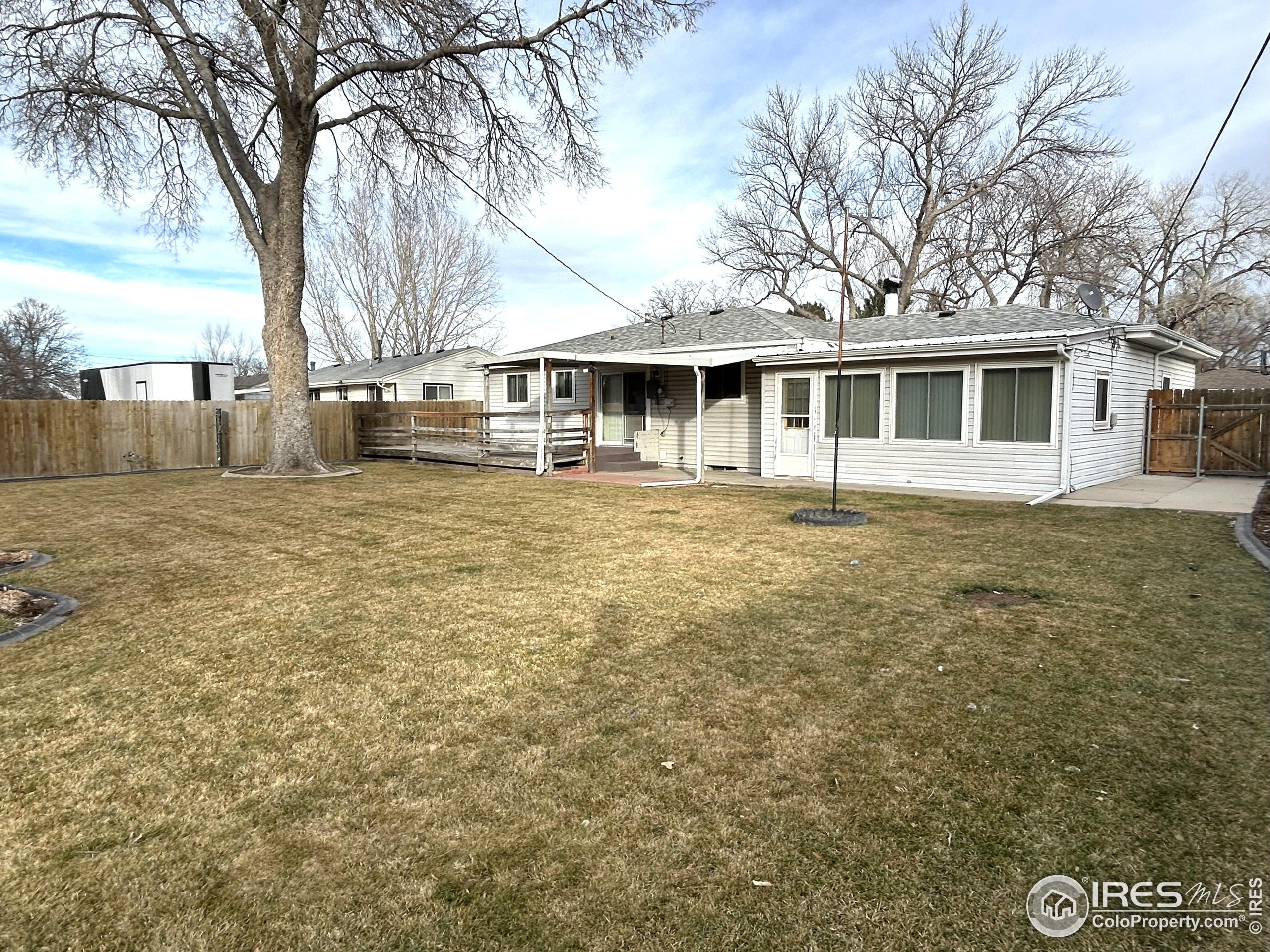 123 Balsam Street Fort Morgan, CO 80701 - Photo 31 of 34 a front view of a house with a garden