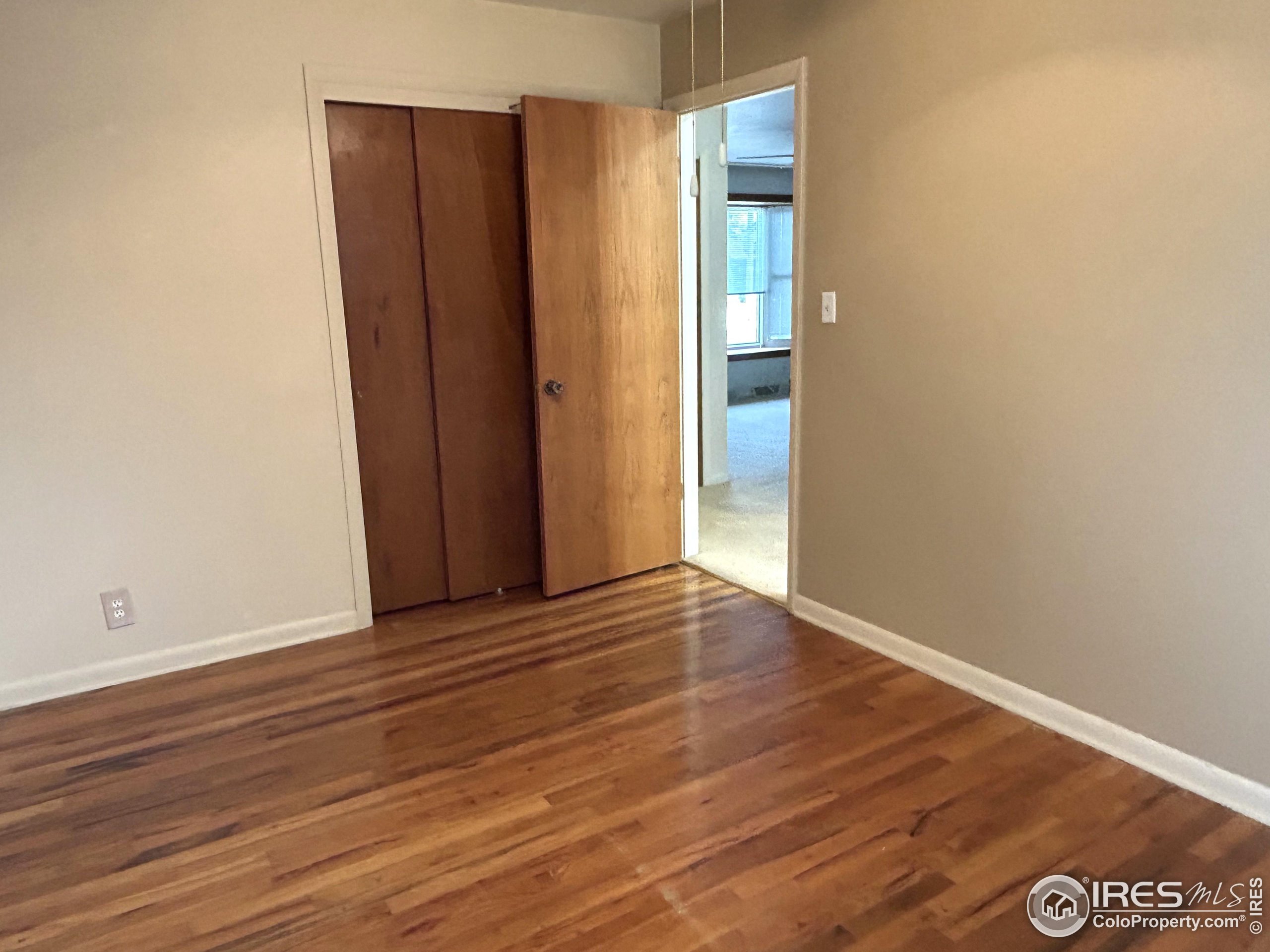 123 Balsam Street Fort Morgan, CO 80701 - Photo 9 of 34 a view of an empty room with wooden floor