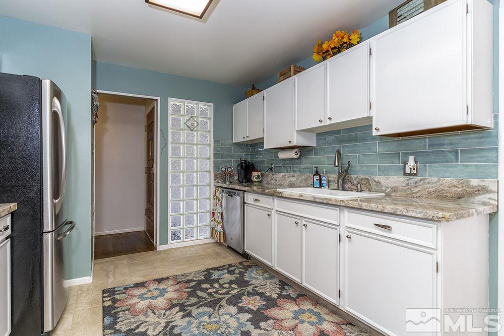 652 James Lane Reno, NV 89503 - Photo 3 of 17 a kitchen with stainless steel appliances granite countertop a refrigerator sink and cabinets