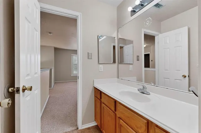 a bathroom with a double vanity sink mirror and shower