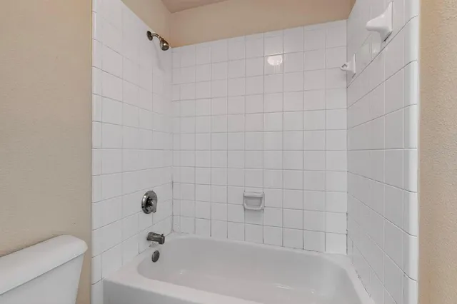 a bathroom with a bathtub and toilet