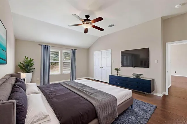 a bedroom with a bed and a flat screen tv