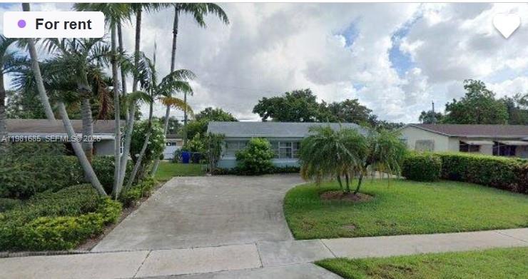 6443 Perry Street Hollywood, FL 33024 - Photo 1 of 24 a front view of a house with a garden