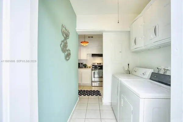 a kitchen with a refrigerator and a stove