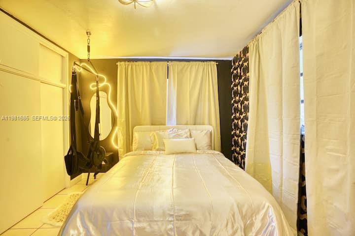 6443 Perry Street Hollywood, FL 33024 - Photo 13 of 24 a bedroom with a bed and a window