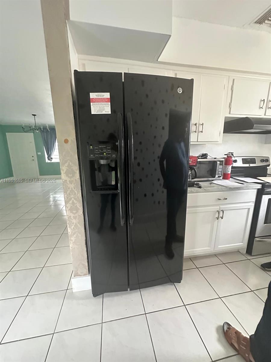6443 Perry Street Hollywood, FL 33024 - Photo 16 of 24 a kitchen with stainless steel appliances granite countertop a refrigerator and a sink