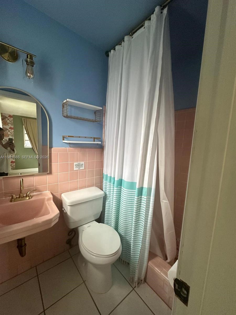 6443 Perry Street Hollywood, FL 33024 - Photo 21 of 24 a bathroom with a toilet a sink and a shower