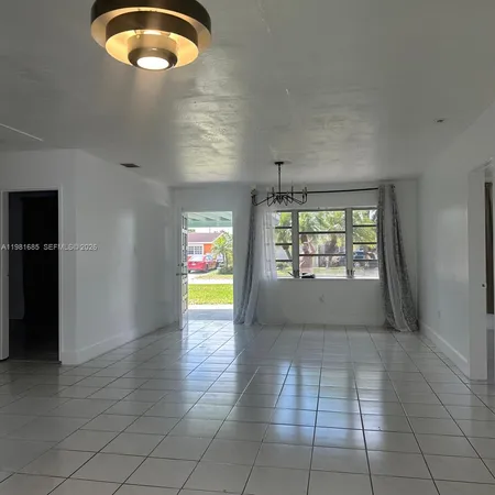 an empty room and chandelier fan view