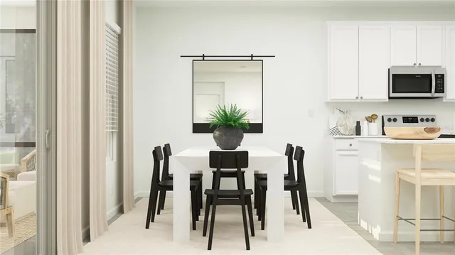 a dining room with furniture and a painting on the wall