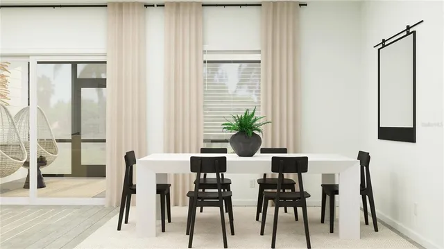 a view of a dining room with furniture and a potted plant