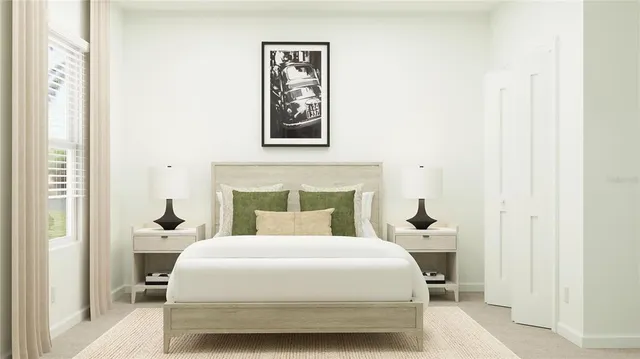 a bedroom with a bed and a painting on the wall