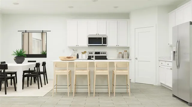 a white kitchen with a sink and a refrigerator
