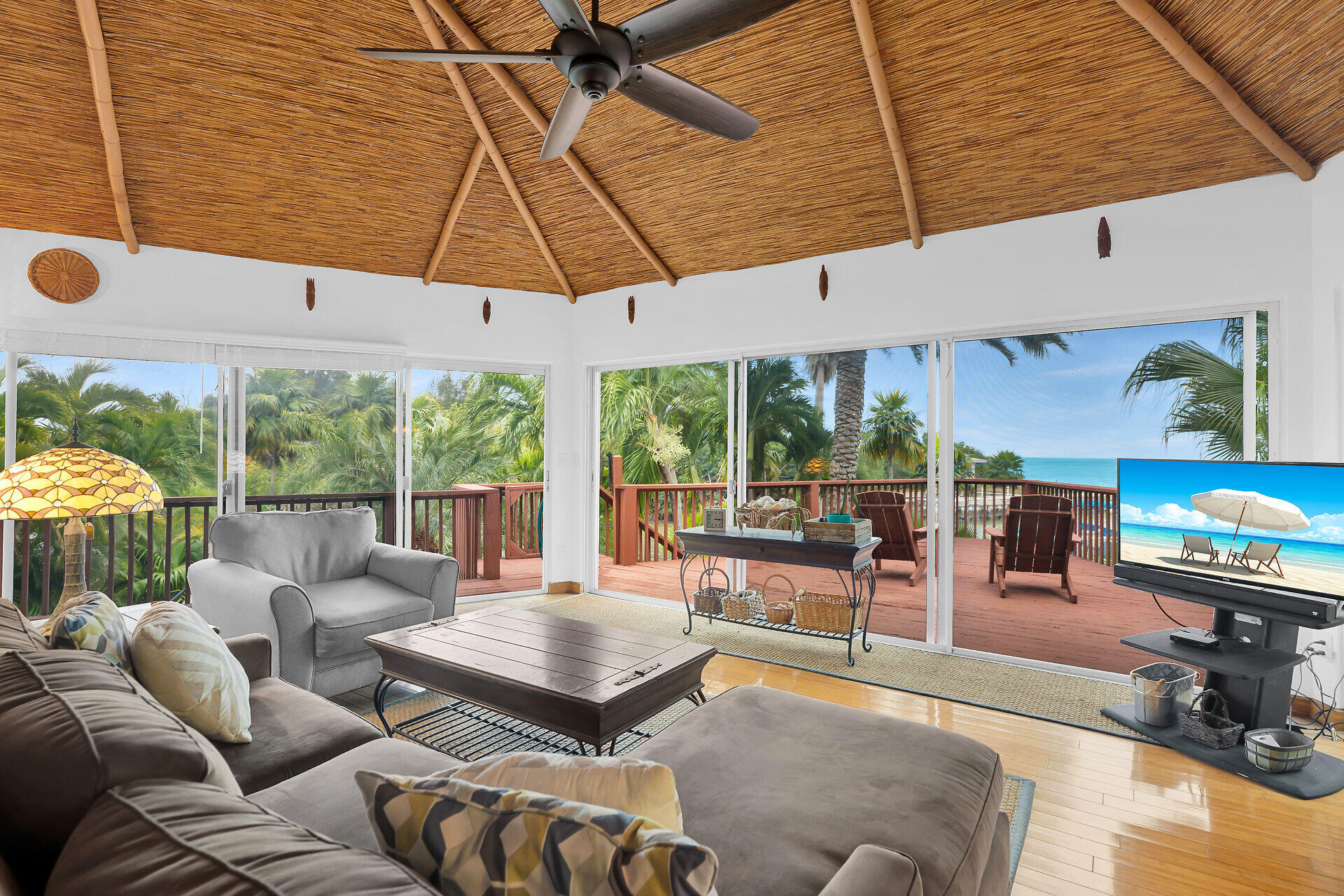 42 Treasure Road Marathon, FL 33050 - Photo 16 of 70 a living room with furniture a table and chairs under an umbrella