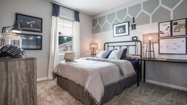 a bedroom with bed and wooden floor