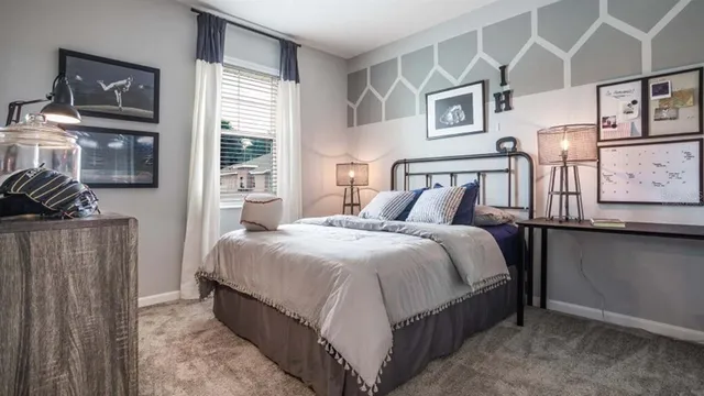 a bedroom with bed and wooden floor