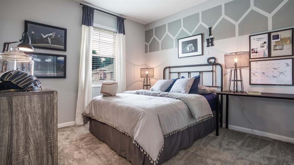 5625 Nina Way St. Cloud, FL 34771 - Photo 6 of 18 a bedroom with bed and wooden floor