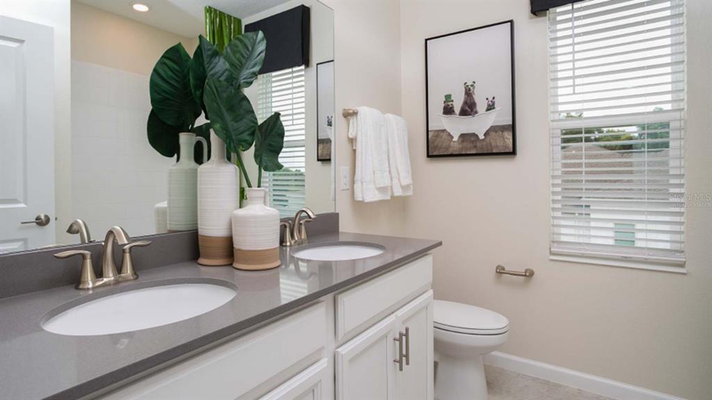 5625 Nina Way St. Cloud, FL 34771 - Photo 7 of 18 a bathroom with a toilet sink and mirror