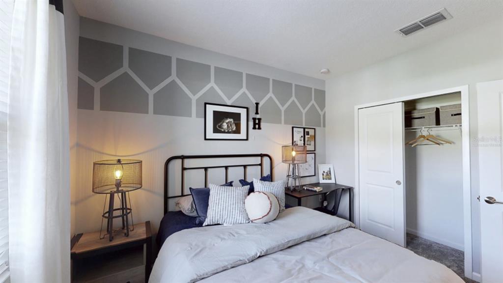 5625 Nina Way St. Cloud, FL 34771 - Photo 8 of 18 a bedroom with a bed and wooden floor