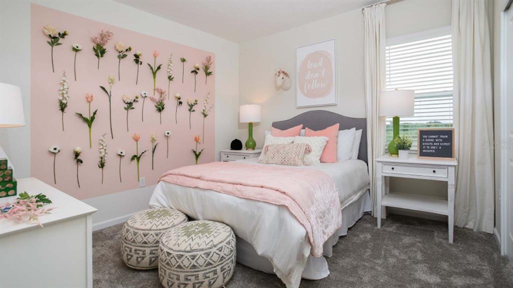 5625 Nina Way St. Cloud, FL 34771 - Photo 9 of 18 a bedroom with a bed and a chandelier