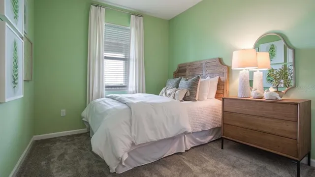 a bedroom with a bed and a mirror