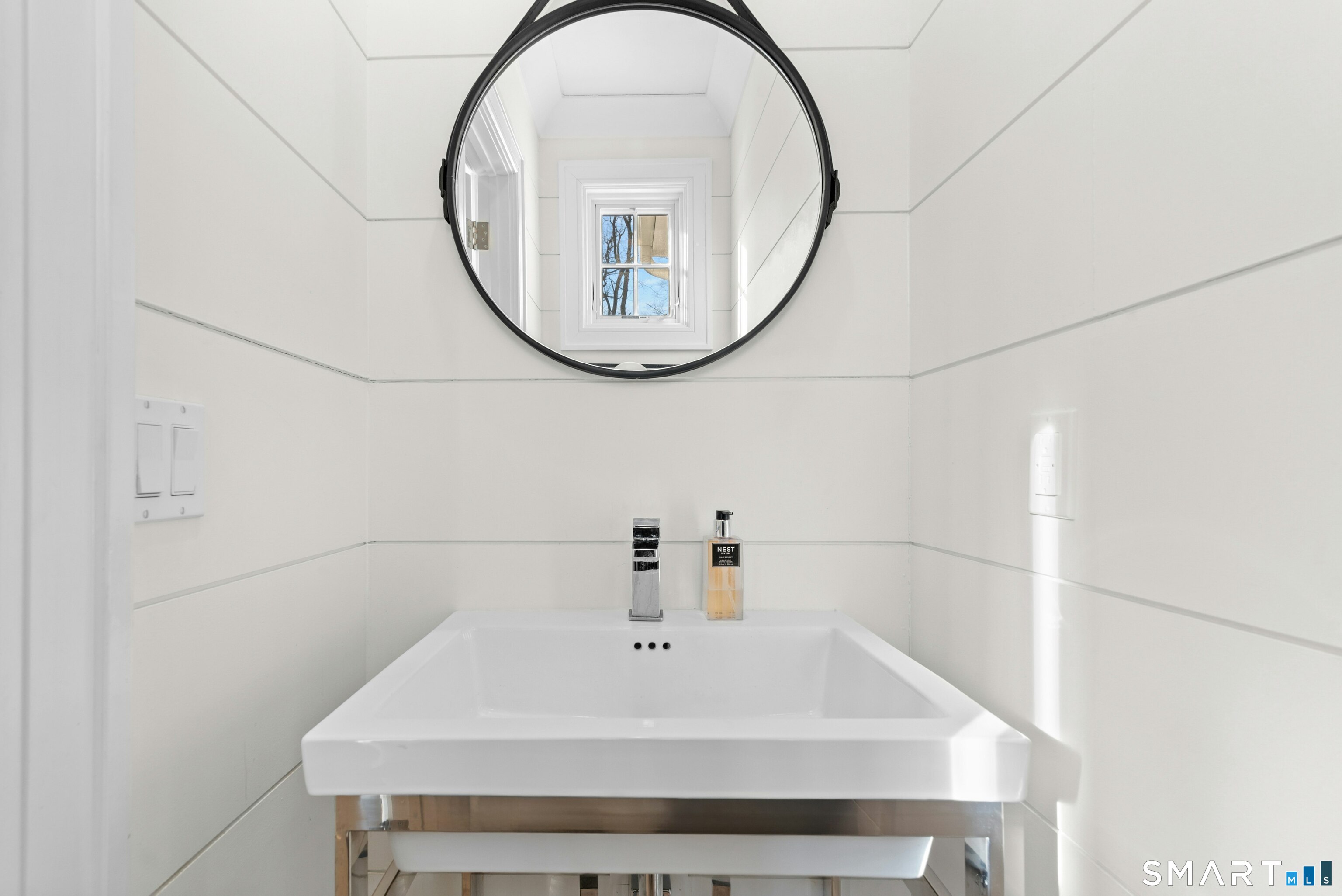 42 Hillcrest Road New Canaan, CT 06840 - Photo 17 of 38 a bathroom with a sink a mirror and a shower