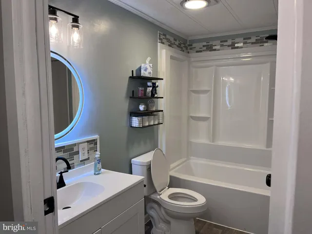 a bathroom with a sink toilet and shower