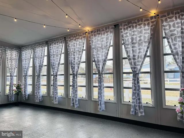 a view of an empty room with windows