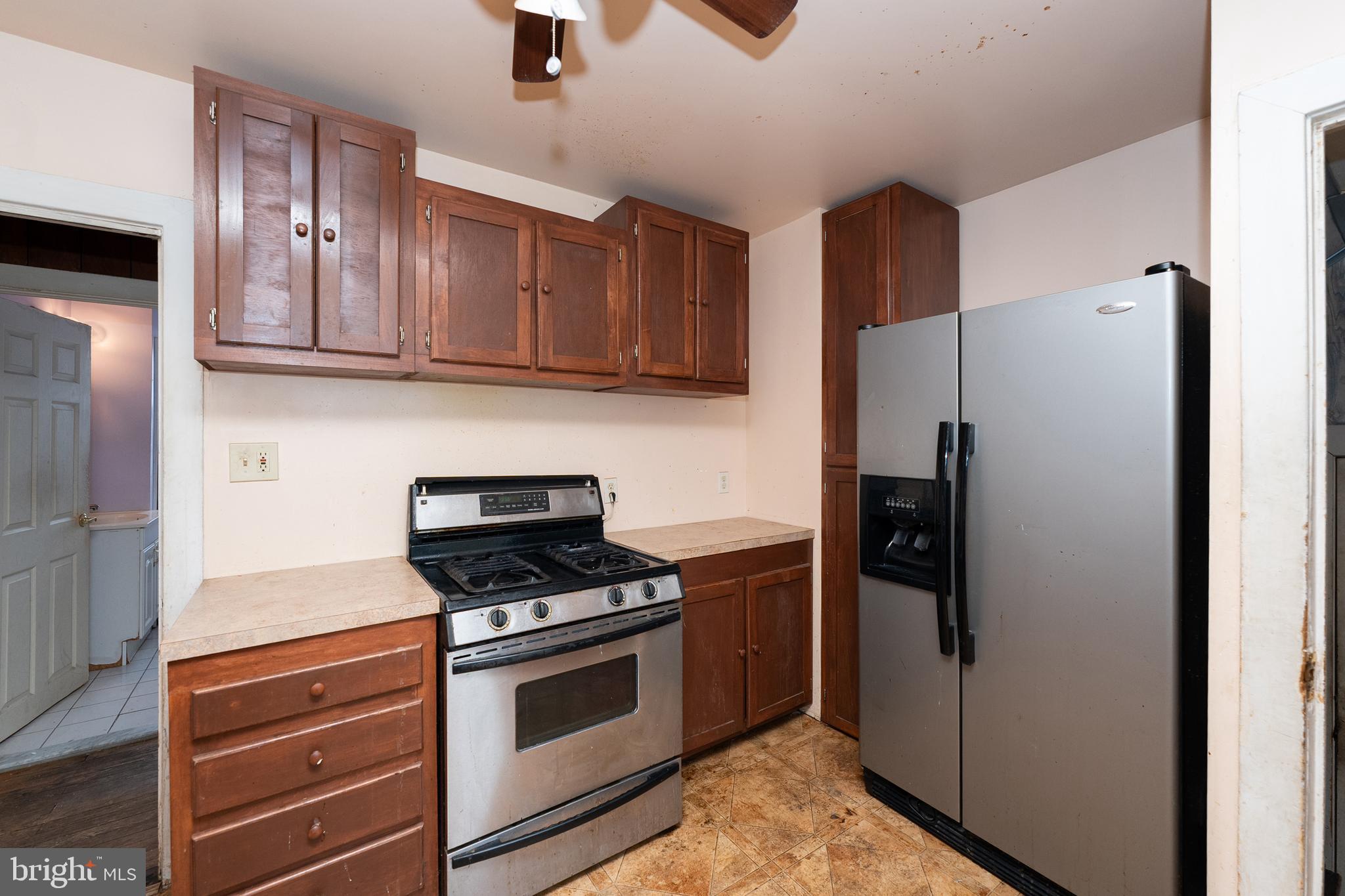 1401 Glassboro Road Wenonah, NJ 08090 - Photo 21 of 41 a kitchen with granite countertop wooden cabinets and stainless steel appliances