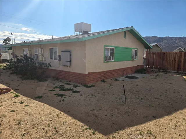 a view of a house with a snow in the background
