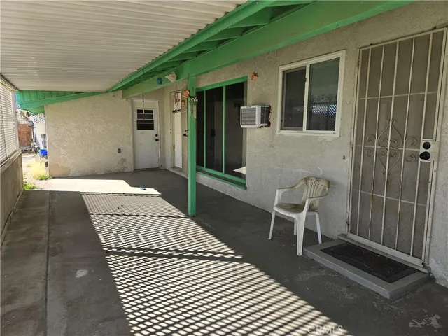 a view of a balcony with chair and front door