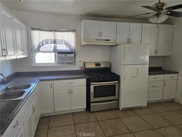 a kitchen with appliances cabinets and a sink