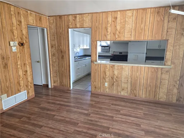 a view of kitchen with wooden floor and electronic appliances
