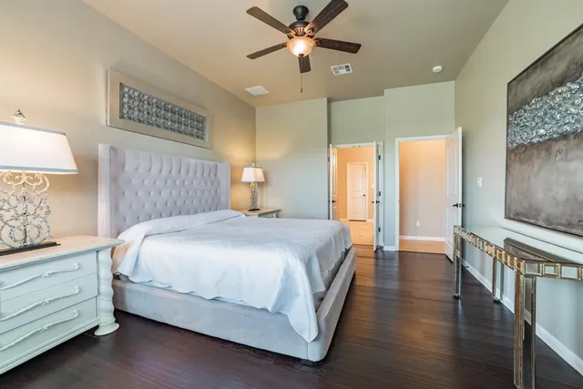 a bedroom with a bed and a chandelier