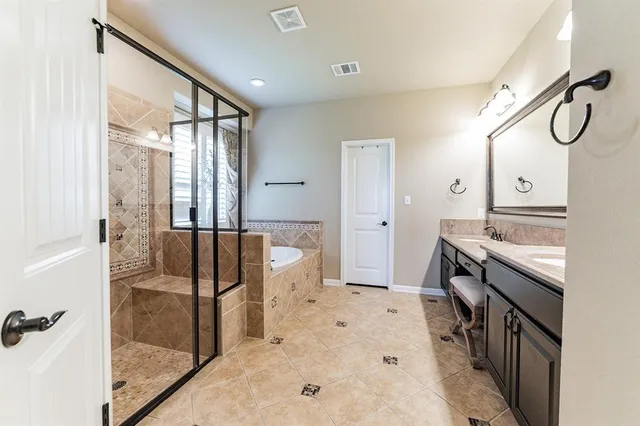 a spacious bathroom with a granite countertop tub sink a mirror and a shower