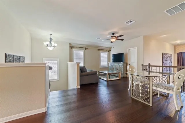 a living room with furniture wooden floor and a flat screen tv
