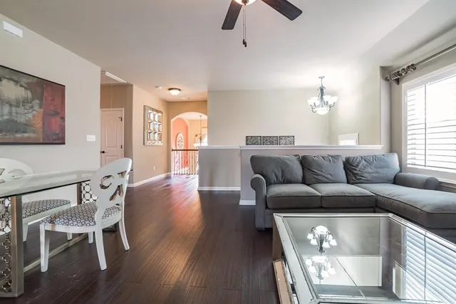 a living room with furniture and a chandelier