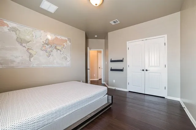 a spacious bedroom with a bed and a window