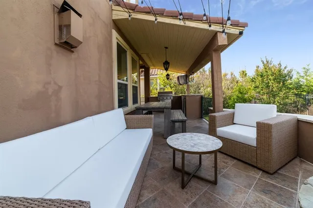 a living room with furniture a table and a potted plant