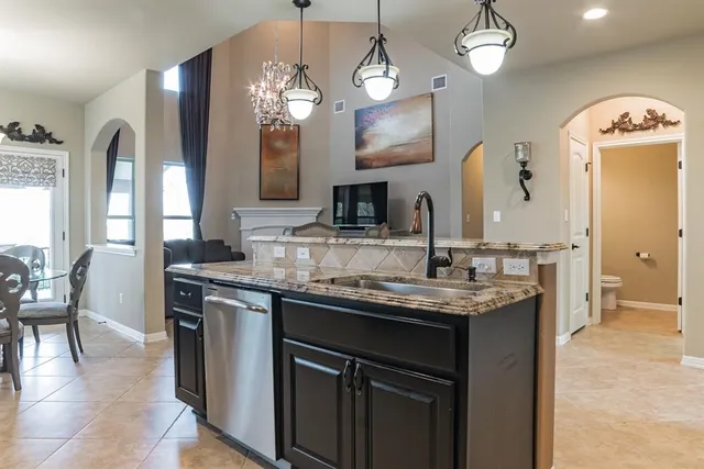 a kitchen with center island table and chairs in it