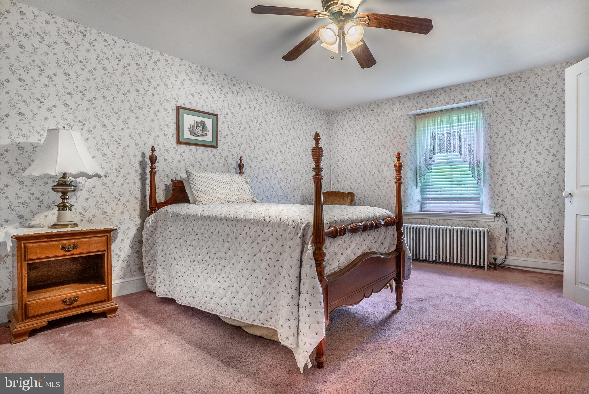 1453 Coldsprings Road Pottstown, PA 19465 - Photo 25 of 53 a bedroom with a bed and a chandelier