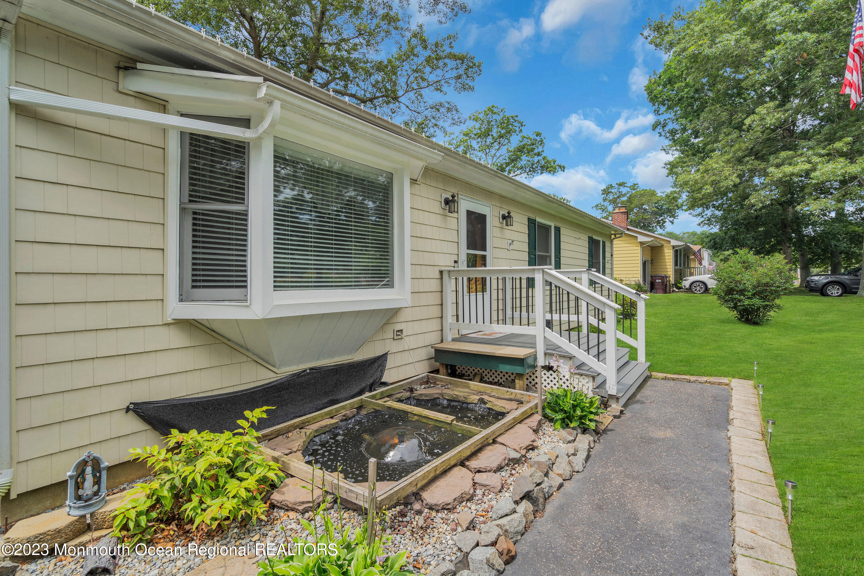 20 Woodland Road Bayville, NJ 08721 - Photo 12 of 62 a front view of a house with garden