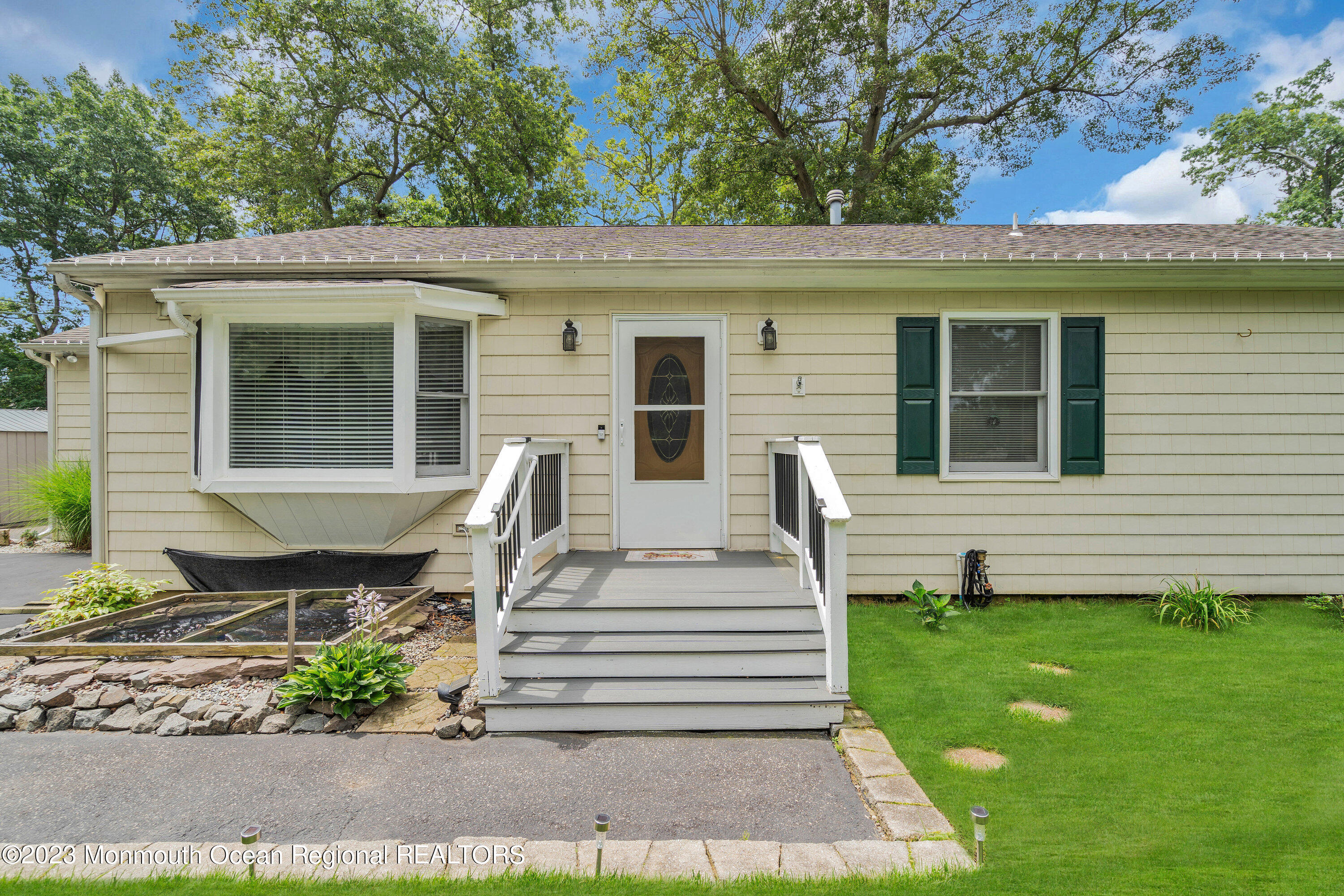 20 Woodland Road Bayville, NJ 08721 - Photo 13 of 62 a front view of a house with a garden