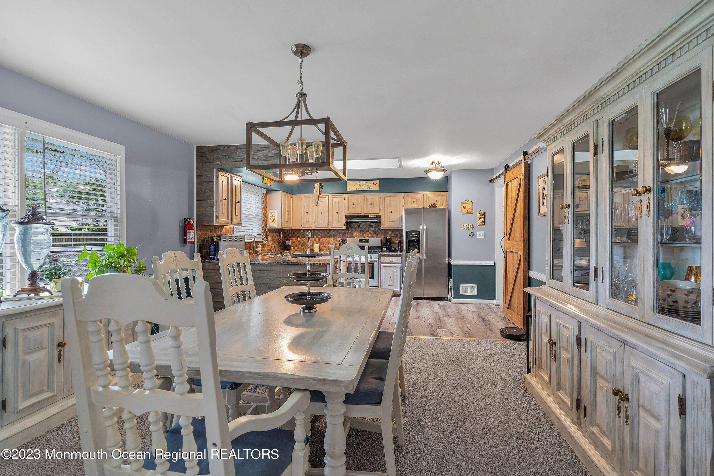 20 Woodland Road Bayville, NJ 08721 - Photo 22 of 62 a view of a dining room and livingroom with furniture large windows a chandelier