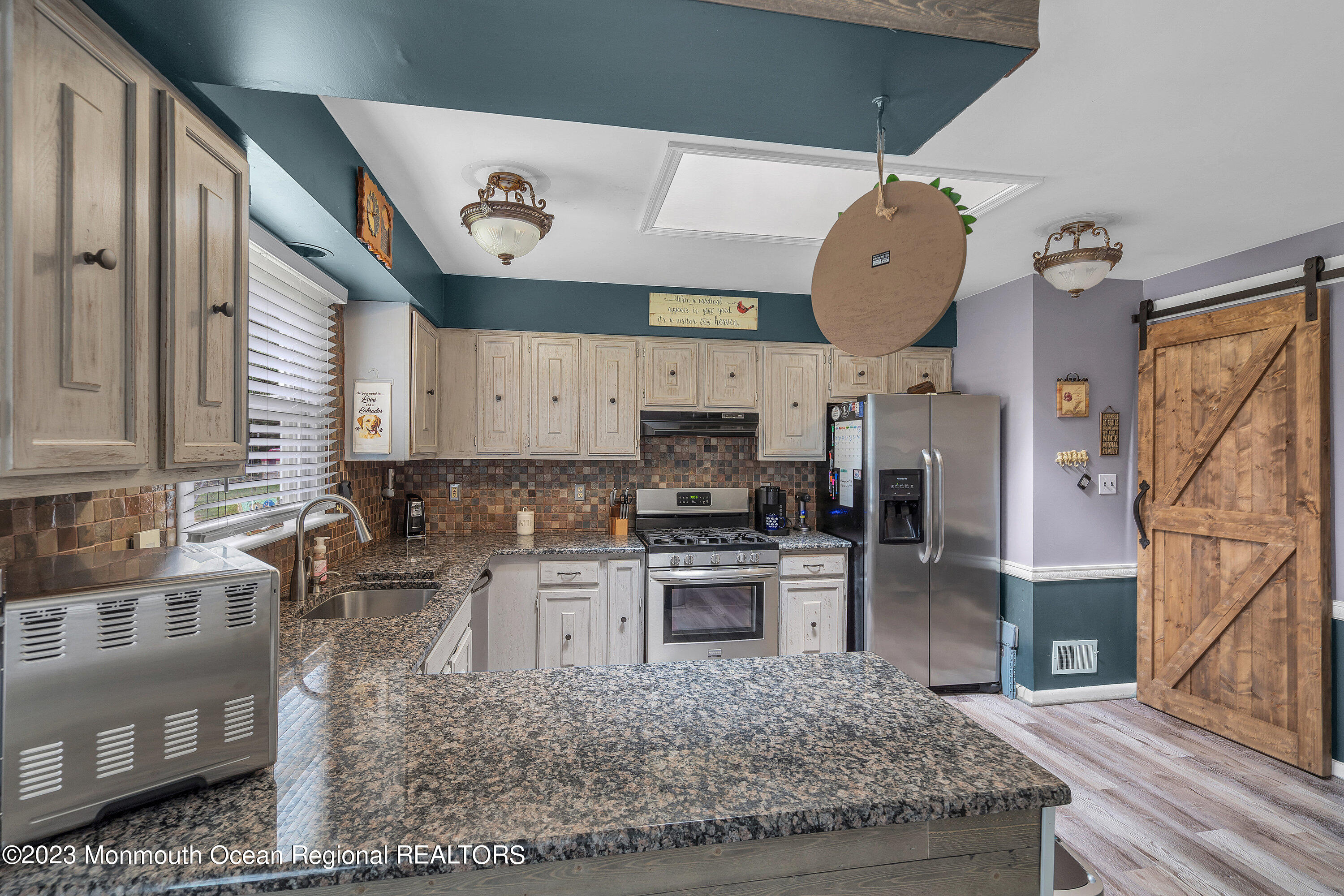 20 Woodland Road Bayville, NJ 08721 - Photo 32 of 62 a kitchen with stainless steel appliances granite countertop a sink a stove and a wooden floors